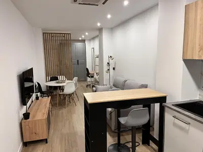 a kitchen and living room with a table and chairs at Loft en puerto de Valencia in Valencia