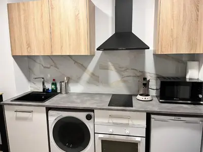 a kitchen with a washing machine and a microwave at Loft en puerto de Valencia in Valencia