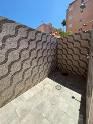 a stone retaining wall with a tile floor at Apartment near the beach in Valencia