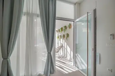 a room with a sliding glass door and a window at RM29 Loft Valencia - Espacioso estudio con terraza en zona Ayora in Valencia