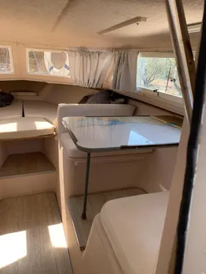 a small room with a table in the inside of a rv at Barco Varado in Gandía