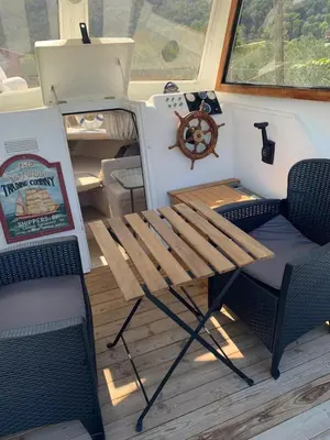a table and chairs on the deck of a boat at Barco Varado in Gandía