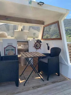 a table and chairs on the deck of a boat at Barco Varado in Gandía