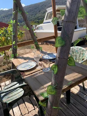 a wooden table with plates and wine glasses on it at Barco Varado in Gandía