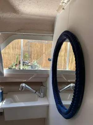 a black hose hanging on a wall next to a sink at Barco Varado in Gandía