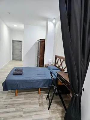 a bedroom with a blue bed and a table at Apart Valencia A in Valencia