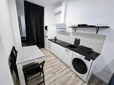 a kitchen with a sink and a washing machine at Apart Valencia A in Valencia