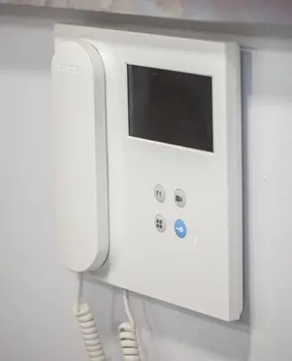 a white phone is attached to a wall at Fantástico apartamento con todos los servicios in Canet de Berenguer