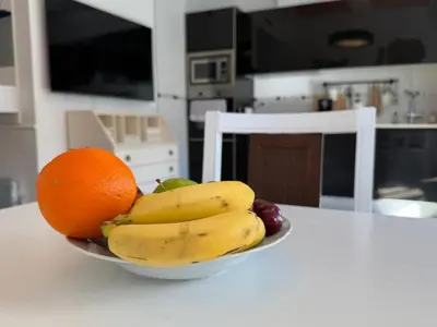 a bowl of fruit on a kitchen table at Reinapart Cabanyal in Valencia