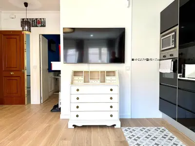 a white dresser with a tv on top of it at Reinapart Cabanyal in Valencia