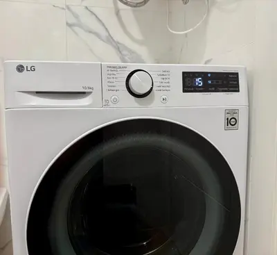 a white washing machine with a clock on it at Reinapart Cabanyal in Valencia