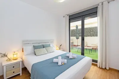 a bedroom with a bed with two towels on it at GuestReady - Lovely home near the beach in Valencia
