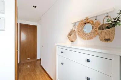 a white kitchen with a dresser and a mirror at GuestReady - Lovely home near the beach in Valencia