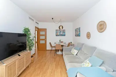 a living room with a couch and a flat screen tv at GuestReady - Lovely home near the beach in Valencia