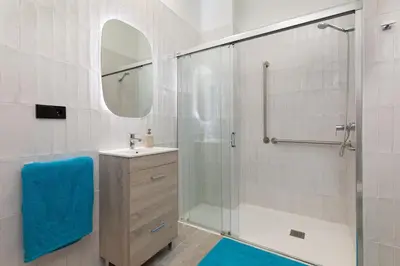 a bathroom with a shower and a sink and a mirror at Apartamento 1º nuevo cerca playa in Valencia