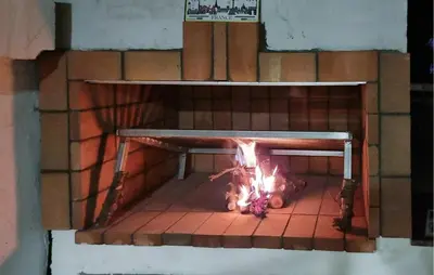 a brick oven with a fire in it at Amazing Home In Macastre With Sauna in Macastre