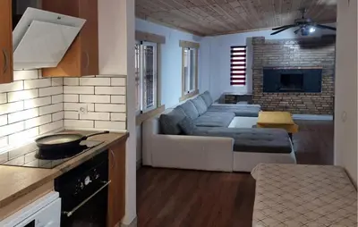 a kitchen and a living room with a couch at Amazing Home In Macastre With Sauna in Macastre