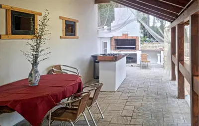 a dining room with a table and chairs and a kitchen at Amazing Home In Macastre With Sauna in Macastre
