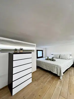 a bedroom with a bed and a dresser at Encanto Rural en Requena in Requena