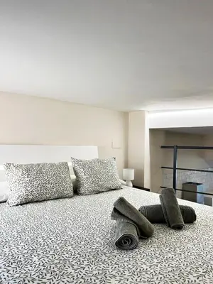 a bedroom with a large bed with two pillows at Encanto Rural en Requena in Requena