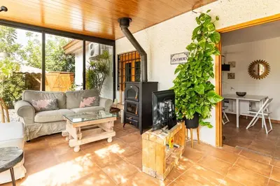 a living room with a couch and a fireplace at Les moreres a space for tranquility in Valencia