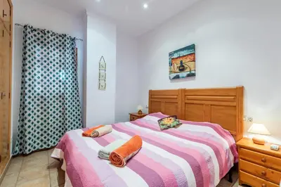 a bedroom with a bed with two pillows on it at Charming apt by the beach with stunning harbor views in Port Saplaya