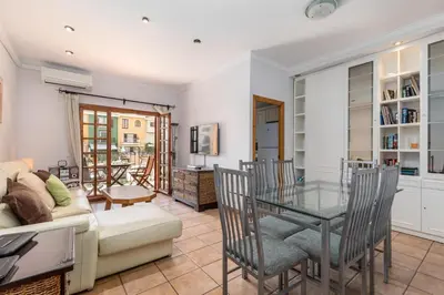 a living room with a glass table and a couch at Charming apt by the beach with stunning harbor views in Port Saplaya