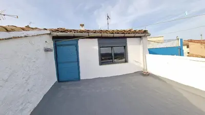 a blue door on the side of a white building at La Replaceta in Segorbe