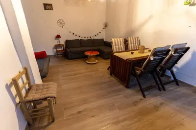 a living room with a couch and a table and chairs at La Replaceta in Segorbe