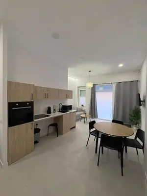 a kitchen and dining room with a table and chairs at Centric Loft near Arts & Science in Valencia
