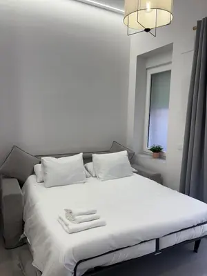 a white bed with towels on it in a room at Centric Loft near Arts & Science in Valencia