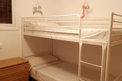 a bedroom with two bunk beds in a room at Cisne! Vistas al mar, piscina y garaje in Cullera