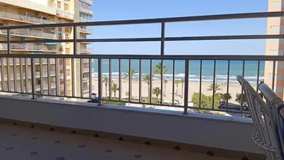 a balcony with chairs and a view of the beach at Cisne! Vistas al mar, piscina y garaje in Cullera
