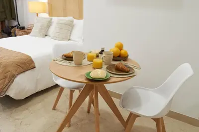 a table with breakfast foods on it next to a bed at Loft 9B JAIME II in Valencia