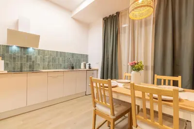 a kitchen and dining room with a table and chairs at Paradise Suite - Cómodo y acogedor - Conectado con Aeropuerto, Playa y Centro in Valencia