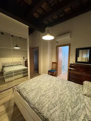 a bedroom with a large bed and a mirror at Miguelete tower & 4th FLOOR & City center and no elevator in Valencia