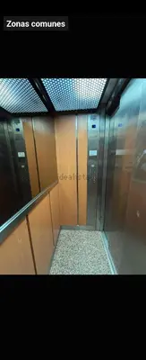 a elevator in a building with wooden doors at Coqueto apartamento en la playa in Puebla de Farnals