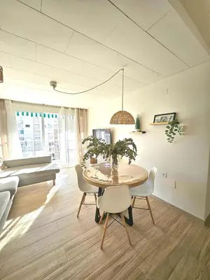 a dining room with a table and chairs at Coqueto apartamento en la playa in Puebla de Farnals