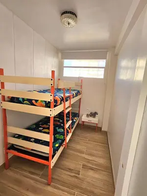 a room with two bunk beds and a window at Coqueto apartamento en la playa in Puebla de Farnals
