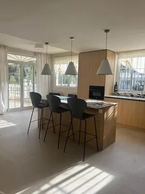 a kitchen with a island with chairs and a counter top at Casa Roka in Alberique