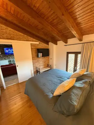 a bedroom with a large bed with pillows on it at Hotel Rural Los Abriles in El Toro