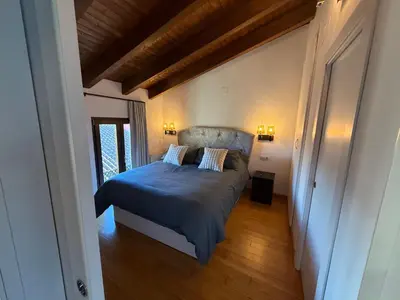 a bedroom with a bed with blue sheets and pillows at Hotel Rural Los Abriles in El Toro