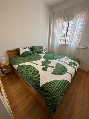 a bedroom with a bed with a green and white comforter at Casa Calma - Modern Apartment, Perfect Location - All you need for a great time in Valencia in Valencia