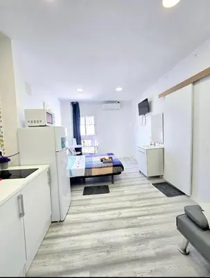 a white kitchen with a bed in a room at Apartamento Metro Manises y Aeropuerto in Manises