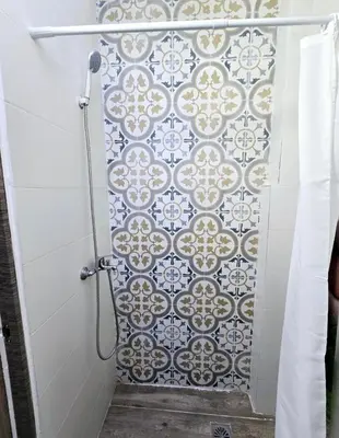 a bathroom with a shower with a tile wall at Apartamento Metro Manises y Aeropuerto in Manises