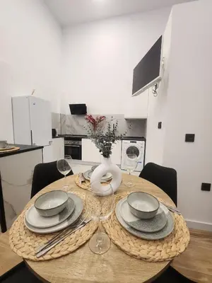 a dining room table with a vase on top of it at kala-mar Valencia in Valencia