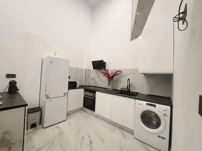 a kitchen with a white refrigerator and a washing machine at kala-mar Valencia in Valencia