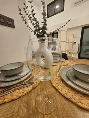 a table with a glass vase on top of a table at kala-mar Valencia in Valencia