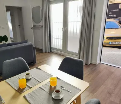 a living room with a table with two glasses of orange juice at District Key - Valencia, Plaza del Cedro in Valencia