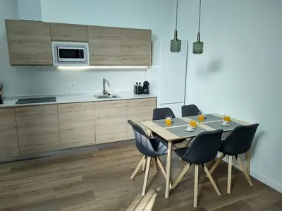 a kitchen with a table and chairs in a room at District Key - Valencia, Plaza del Cedro in Valencia
